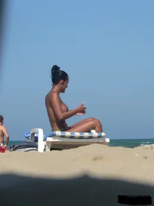 Hot ass topless beach girl with great tits lets her little brother oil up her ass in thong bikini