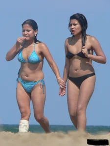 Couple of thick beach teens in little thong bikinis