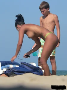 Hot ass topless beach girl with great tits lets her little brother oil up her ass in thong bikini