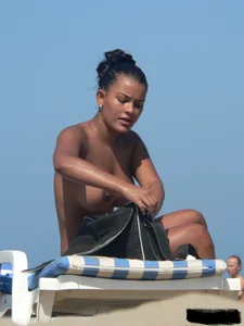 Hot ass topless beach girl with great tits lets her little brother oil up her ass in thong bikini