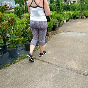 Milf booty in tight leggings shopping for plants