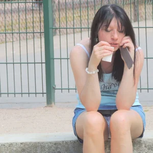 Brunette sitting upskirted showing her white lace panties