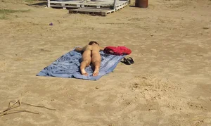 Babe laying out in the sun in black thong with top off