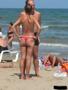 A bunch of hot babes on the beach in thong bikinis