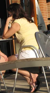 Lady in flop flops while eating showing her feet