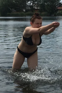 Big boobed babe at the lake in a black thong with blonde friend