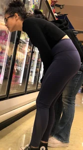 Girl with glasses shopping in leggings showing her VPL
