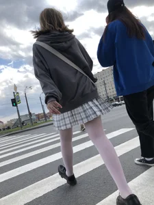 Candid teen girl wearing a skirt and white pantyhose crossing the street creepshots