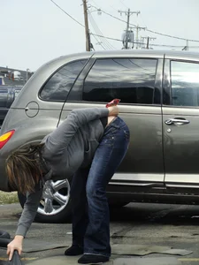 Girl cleaning her car in jeans and showing some cheetah print underwear