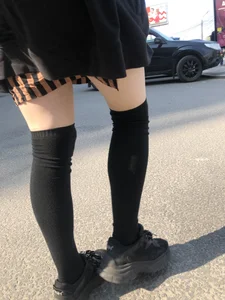 Legs in Knee-Socks And a Skirt - Young Girl Passing By on the Street