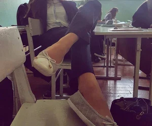 College Teen Sitting With Her Feet in Flats Placed on Chair Classroom Photo