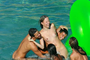 FKK Nudists playing in the water with floater