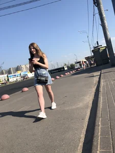 A very cute street candid girl wearing a denim fringed skirt passing by, great legs