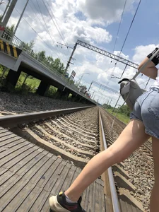 Cute Girl in Denim Shorts Walking Down a Railway Station Gallery