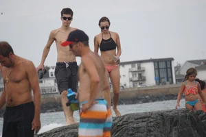 Peach bikini tattood babe on the beach with a nice ass and some camel toe