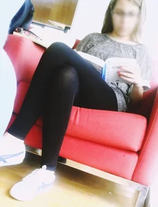 A Skinny Candid Girl in Black Pantyhose And Sneakers Reading on a Library Couch With Crossed Legs Creepshots