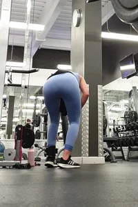Bending gym babe stern face