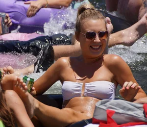 Sexy party girls in bikinis on a lake
