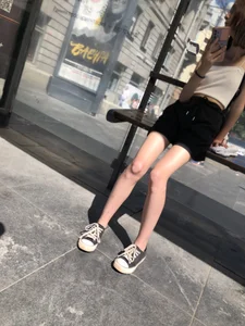 A Very Skinny Teen in Shorts And a Top At the Bus Stop