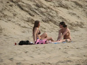 Topless beach girl with nice titties with her friend in a bikini