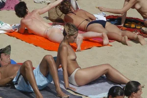 Topless girls on a beach in Barcelona