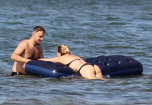 Black thong bikini blonde with a nice ass out on a tube in the water