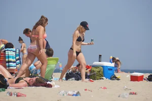 Two thick white girls in bikinis on the beach with big asses