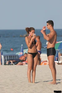 A bunch of sexy beach voyeur babes in bikinis, thongs and topless