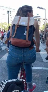 Blonde girl on a bike with a big tight ass in tight jeans
