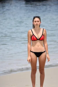 Sexy chick in red and black bikini on the beach
