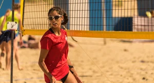 Hot girls playing beach volleyball in bikinis and shorts