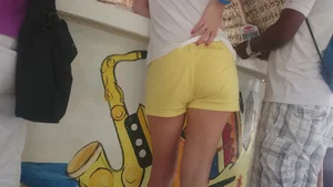 Milf in yellow shorts with vpl and a wedgie
