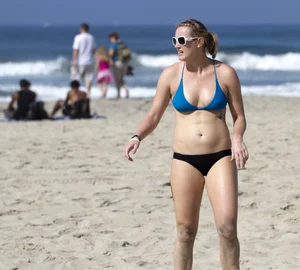Hot girls playing beach volleyball in bikinis and shorts