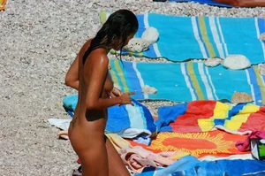 Ula FKK Sexy brunette on a nude beach topless, bottomless and with blue thong