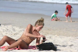 Sexy girls topless on a nude beach showing their nice tits