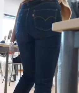 Candid college girl in class, closeup of her booty and legs in tight blue jeans