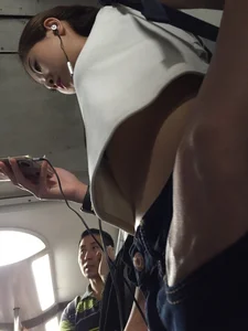 Sexy Asian showing bra under shirt and a little cleavage