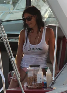 Bikini babe on a boat with a wet see through white shirt showing her tits