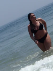 Thick beach babe with big tits in a thong bikini