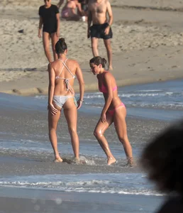 Two sexy friends out on the beach in bikinis