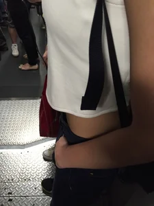 Sexy Asian showing bra under shirt and a little cleavage