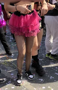 Hot carnival girl in in a top, mini shorts with pink frill and awesome legs in fishnet pantyhose