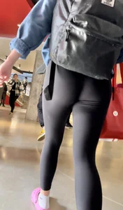 College girl going up the stairs with leggings and pink crocs