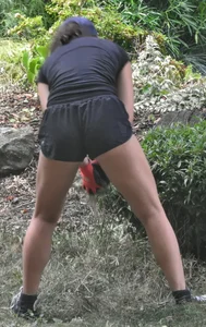Brunette gardener in shorts bends over… and over as she works [085]