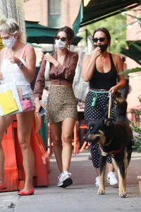 Emily Ratajkowski in mini skirt out for a walk with a friend in New York
