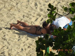 Big booty beach babe laying out in thong