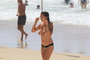 Sexy girls topless on a nude beach showing their nice tits