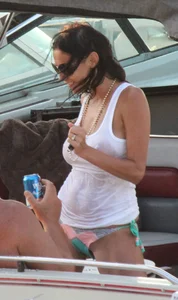 Bikini babe on a boat with a wet see through white shirt showing her tits
