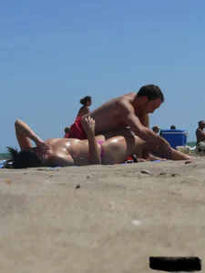 Purple thong topless lady on the beach gets oiled up by her husband