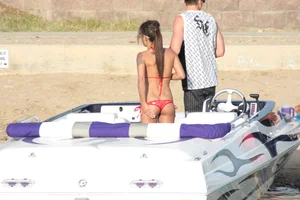 Brunette on a boat in red thong bikini with a tight little ass